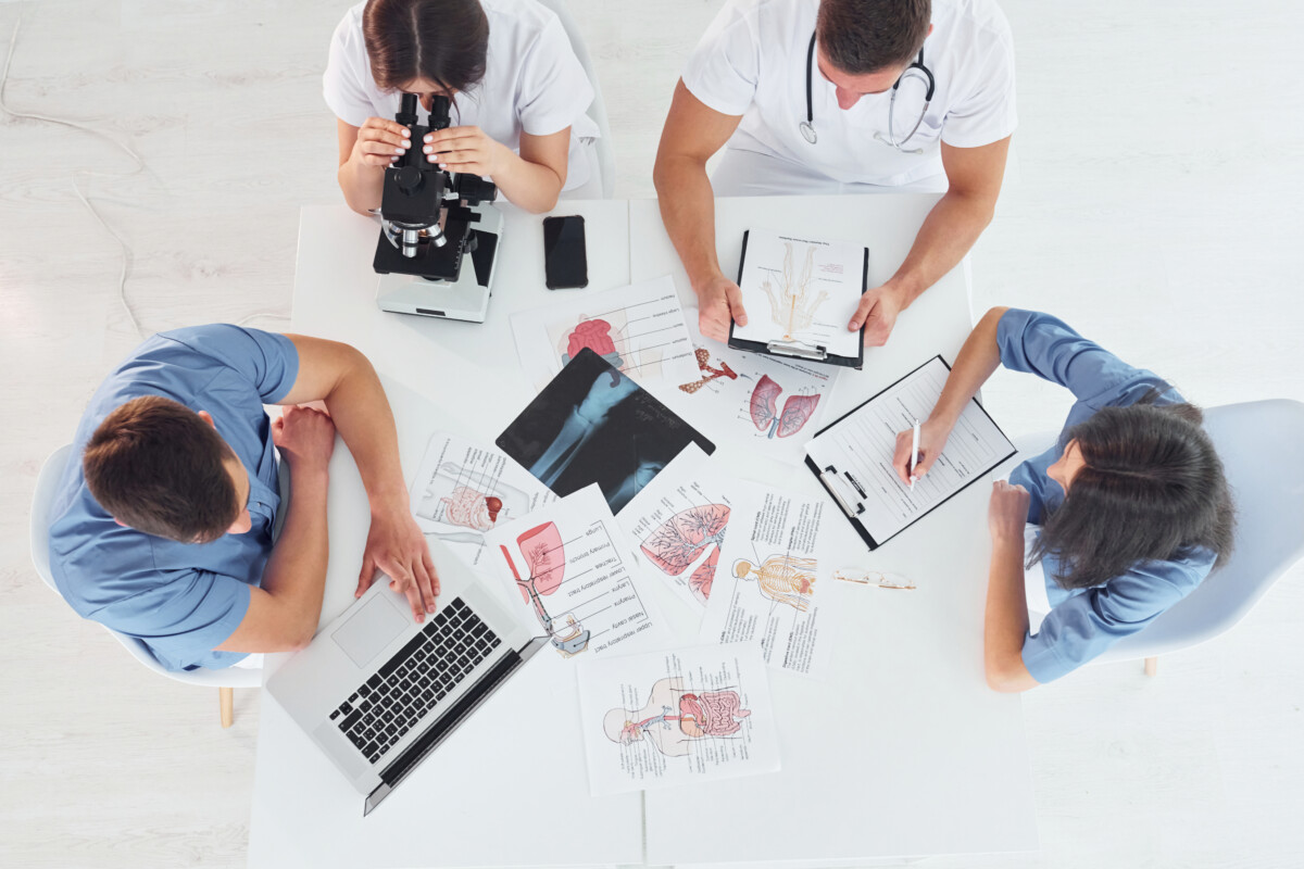 Top view. Group of young doctors is working together in the modern office